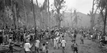 In this August 1944 file photo, people of Guam pour out of the hills into the Agana refugee camp. (Joe Rosenthal/AP)