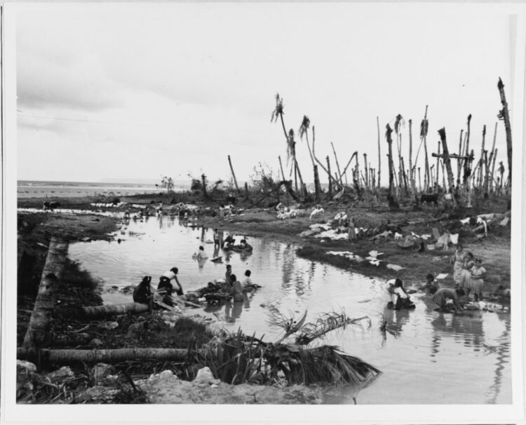 Woman washing cloths in a creek near Agana, Guam on 12 August 1944. Source: National Archives
